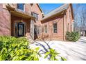 Elegant brick home exterior with a beautifully landscaped front yard and stone accents on the column and entrance at 297 Collegiate Dr, Powder Springs, GA 30127