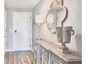 Hallway featuring a decorative sideboard with lamps and a stylish mirror at 3338 Peachtree Ne Rd # 1507, Atlanta, GA 30326