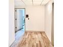 Neutral hallway with wood-style floors, leading to a bright, open door at 3338 Peachtree Ne Rd # 1507, Atlanta, GA 30326