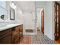 Elegant bathroom with a glass-enclosed shower, double vanity, and patterned tile flooring at 563 Ralph Mcgill Ne Blvd, Atlanta, GA 30312