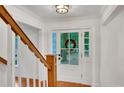 Bright foyer with hardwood floors, white trim, and a beautiful wood and white staircase at 1610 Old Mill Xing, Marietta, GA 30062