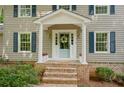 Inviting front porch featuring a blue door, brick steps, and classic white columns and shutters at 1610 Old Mill Xing, Marietta, GA 30062