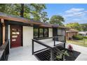 Inviting front porch with modern cable railings and freshly landscaped area, offering a welcoming entrance to the renovated home at 1853 Pinedale Pl, Decatur, GA 30032