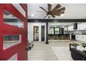 Open-concept living space flows into the remodeled kitchen with modern finishes, and features an open entry with a stylish front door at 1853 Pinedale Pl, Decatur, GA 30032
