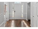 Inviting entryway with hardwood floors, white wainscoting, and a bright front door with sidelights at 4021 Melvin Sw Dr, Atlanta, GA 30331