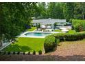 Serene backyard oasis with a sparkling pool, lush lawn, and plenty of space for outdoor entertaining at 4095 N Broadland Nw Rd, Atlanta, GA 30342
