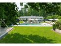 Inviting backyard with a refreshing pool, sun loungers, and a manicured lawn, perfect for relaxation and leisure at 4095 N Broadland Nw Rd, Atlanta, GA 30342