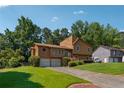 Suburban home featuring an attached two-car garage and a lush green lawn at 1159 Midland Nw Dr, Acworth, GA 30102