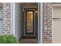 Close-up of the home's front door with glass detailing and brick and siding entryway at 3931 Fireoak Dr, Decatur, GA 30032