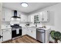 Modern kitchen with stainless steel appliances, updated cabinets, and new countertops at 90 Lake Avalon Ct, Dallas, GA 30157
