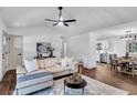 Bright living room features a modern ceiling fan, wood floors and new paint at 90 Lake Avalon Ct, Dallas, GA 30157