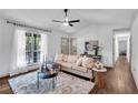 Well-lit living room with a cozy sofa, large window, and stylish decor at 90 Lake Avalon Ct, Dallas, GA 30157