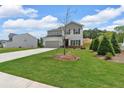 Beautiful home with manicured lawn and landscaping, showcasing a long concrete driveway at 4563 Sweetlake Court Sw, Mableton, GA 30127