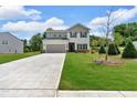 Beautiful two-story house featuring a well-kept lawn and a long concrete driveway at 4563 Sweetlake Court Sw, Mableton, GA 30127