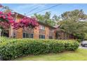A lush green lawn and landscaping surround this brick exterior condo building at 115 Biscayne Nw Dr # E3, Atlanta, GA 30309