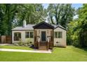 Inviting home featuring a cozy front porch, freshly painted exterior, and beautifully landscaped front yard at 345 Adelle Se St, Atlanta, GA 30315