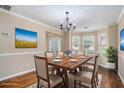 Elegant dining room with a wood table, chandelier lighting, and large windows for a bright and welcoming space at 555 Sydney Crest Ln, Lawrenceville, GA 30046