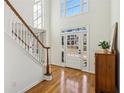 Bright foyer with hardwood floors, staircase and large windows providing an abundance of natural light at 7115 Doncaster Ct, Cumming, GA 30040