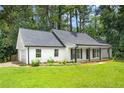Attractive home featuring an attached garage, manicured lawn, classic shutters and welcoming front porch at 2487 Highland Se Dr, Conyers, GA 30013