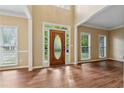 Bright foyer featuring hardwood floors, a decorative front door, and natural light from many windows at 3355 Golfe Links Dr, Snellville, GA 30039