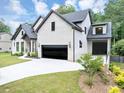 Stunning two-story home with a well-manicured lawn, a modern garage, and sleek architectural details at 3562 Clubland Dr, Marietta, GA 30068