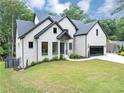 Beautiful white brick home featuring black trim, a dark roof, and a spacious driveway at 3562 Clubland Dr, Marietta, GA 30068