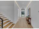 Bright hallway featuring hardwood floors, recessed lighting, and modern decor, creating an inviting entrance at 3562 Clubland Dr, Marietta, GA 30068