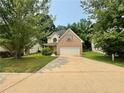 Charming two-story brick home with well-manicured lawn and a long driveway, perfect for Gathering living at 105 Avonwood Cir, Locust Grove, GA 30248