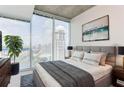 Cozy main bedroom with large windows offering city views, featuring modern decor and plush bedding at 3324 Peachtree Ne Rd # 1604, Atlanta, GA 30326