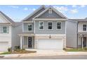 Stylish two-story home featuring gray siding, a stone-accented garage, and a welcoming front porch at 4778 Moonstone Trce, Kennesaw, GA 30144