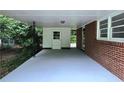 Spacious carport with access to the house and a storage area, providing convenience and protection from the elements at 813 Crockett Ct, Decatur, GA 30033