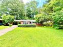 Classic brick home featuring a lush green lawn, mature trees, and a tidy, inviting exterior at 813 Crockett Ct, Decatur, GA 30033