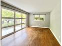 Bright living room with hardwood floors and large windows offering plenty of natural light and backyard views at 813 Crockett Ct, Decatur, GA 30033