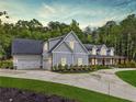 Stately home featuring an attached three car garage and manicured lawn at 540 Byrd Mountain Ln, Canton, GA 30114