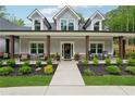 Inviting front porch with seating and a beautifully landscaped garden at 540 Byrd Mountain Ln, Canton, GA 30114