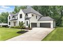 Beautiful two-story home showcasing a well-manicured lawn and an attached two-car garage at 6175 River Shore Pkwy, Atlanta, GA 30328