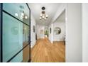 Bright foyer with hardwood floors, modern lighting and a glass front door at 6175 River Shore Pkwy, Atlanta, GA 30328