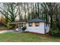 Inviting exterior showcasing a manicured lawn, carport, and freshly painted facade at 2895 Akron St, Atlanta, GA 30344