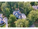Aerial shot of a home nestled among mature trees in a quiet neighborhood at 4030 Greatwood Path, Alpharetta, GA 30005