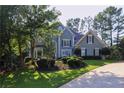 Charming two-story home with a well-manicured lawn and mature trees at 4030 Greatwood Path, Alpharetta, GA 30005