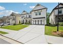 Stunning two-story home with a long driveway, white siding, and black trim at 4189 Brookmont Way, Auburn, GA 30011