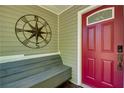 Close-up of the red front door with decorative accents and a compass star wall decoration at 224 Amy Blvd, Temple, GA 30179