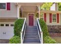 Inviting front porch with steps, decorative columns, and a stylish red front door at 224 Amy Blvd, Temple, GA 30179