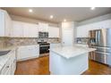 Modern kitchen featuring a center island, stainless appliances, and granite counters at 3405 Linstead Ct, Loganville, GA 30052