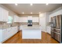Bright kitchen with white cabinets, granite countertops, and stainless steel appliances at 3405 Linstead Ct, Loganville, GA 30052