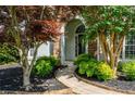 Elegant front entrance with stone archway and manicured landscaping at 2000 Settindown Dr, Roswell, GA 30075