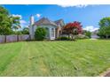 Well-maintained front yard showing the side of the home and fresh cut grass at 2000 Settindown Dr, Roswell, GA 30075