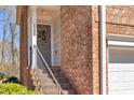 Charming front door with a decorative wreath and a brick facade at 420 Heritage Park Nw Trce # 22, Kennesaw, GA 30144