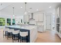 Modern kitchen featuring a large center island, stainless steel appliances and barstool seating at 461 Maypop Ln, Woodstock, GA 30188