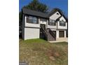 Charming two-story home featuring a brick foundation, stairs leading to the front door, and a well-kept lawn at 955 Loch Forest Way, Riverdale, GA 30296